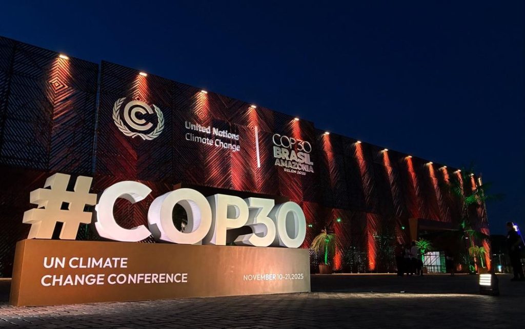 Huge 3D '#COP30' signage at a night-time UN Climate Change Conference venue in Brasil, Amazonia district.