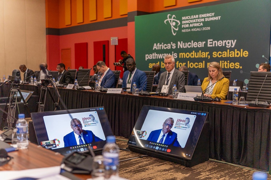Conference panel at a summit on Africa's nuclear energy, with a banner reading 'Africa's Nuclear Energy pathway…' and attendees seated around a long table.